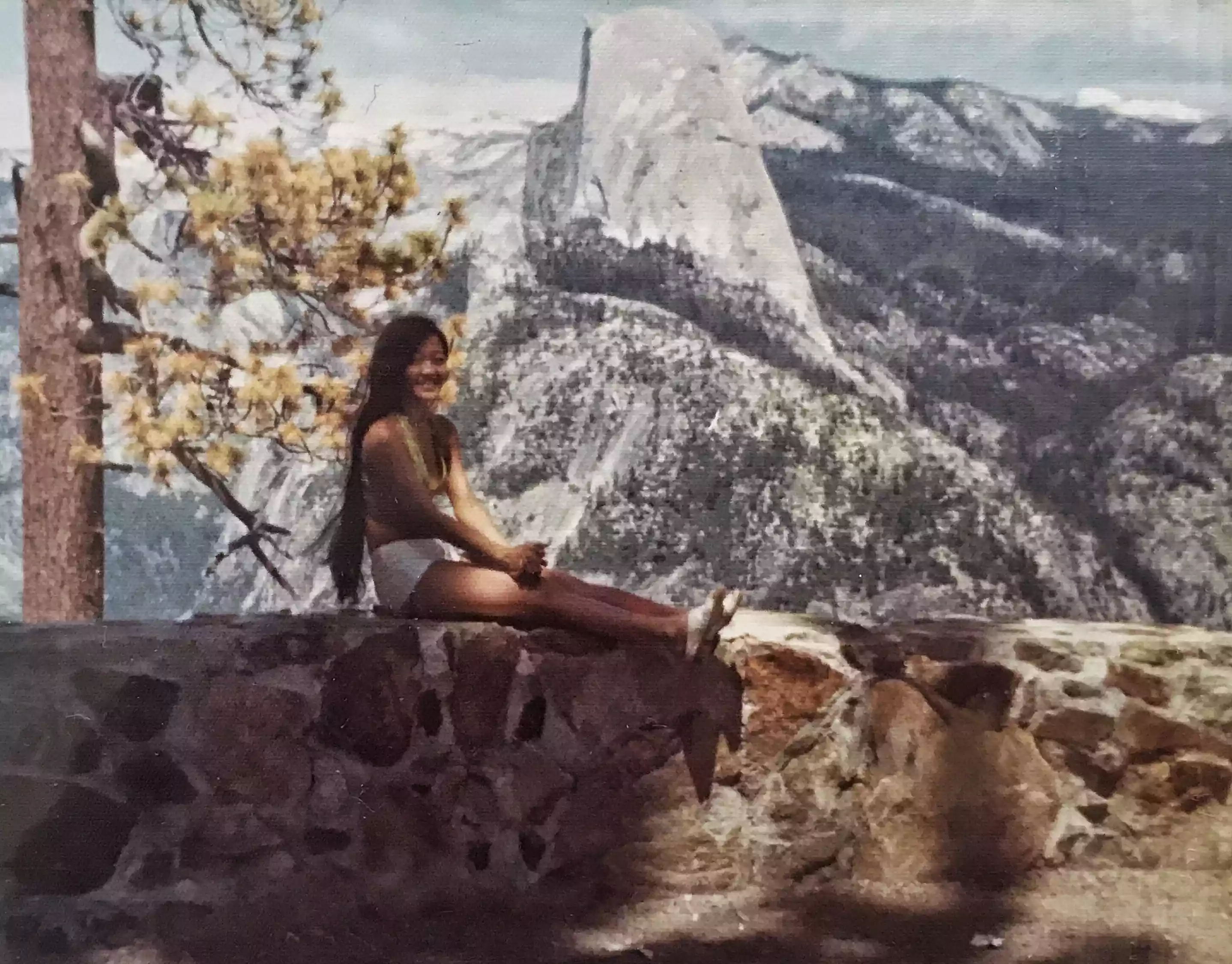 woman sitting with mountain in background
