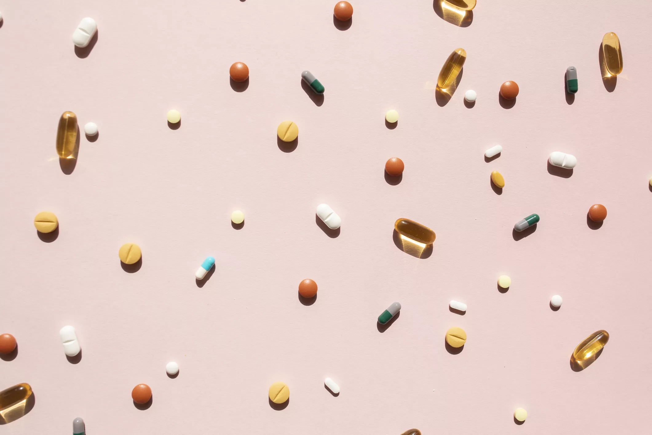 vitamins on pink background