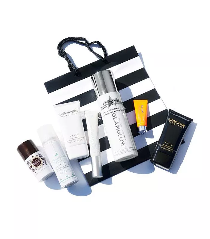 Assortment of beauty products atop Sephora shopping bag