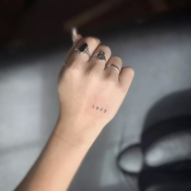 Small hand tattoo of number 1949