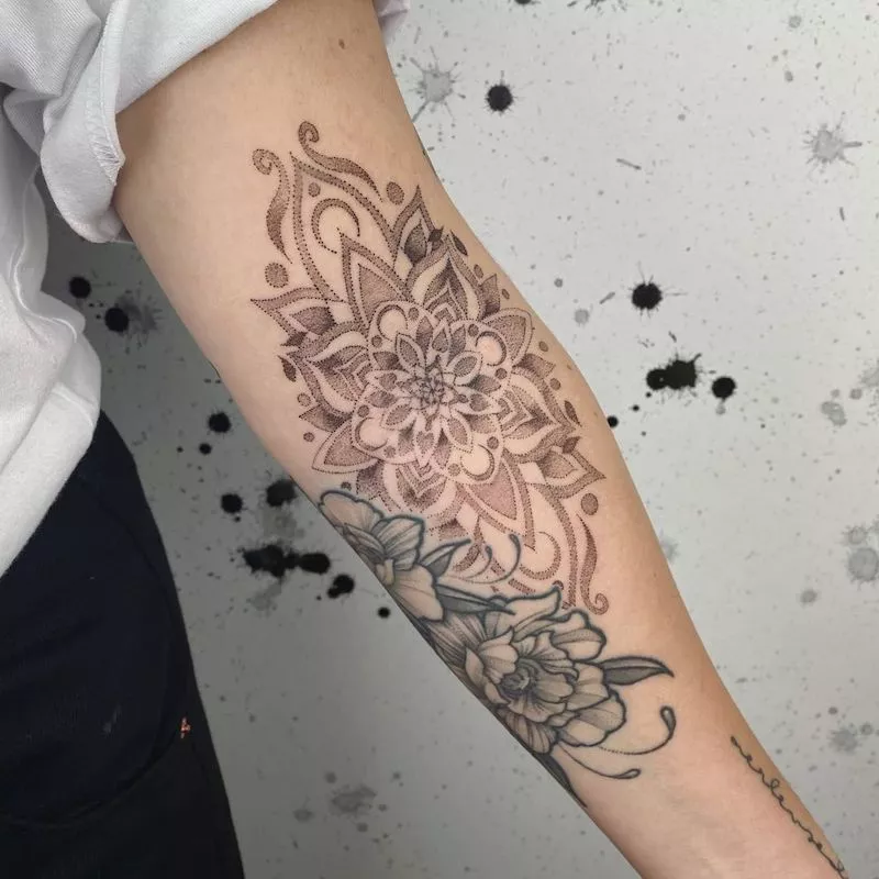 Large mandala tattoo with flowers on arm