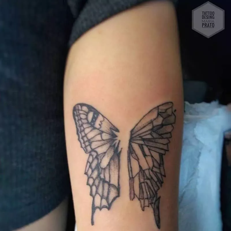 Butterfly wings tattoo on upper arm