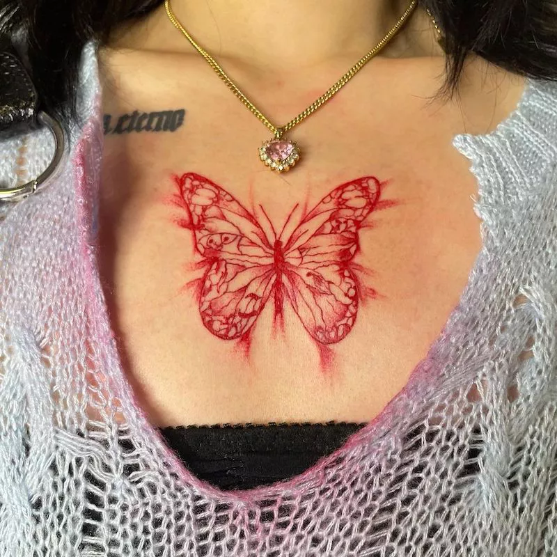 Red butterfly tattoo on chest