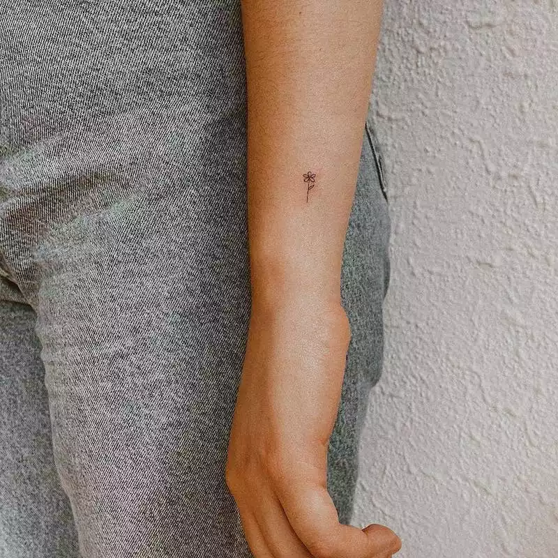 Small flower wrist tattoo