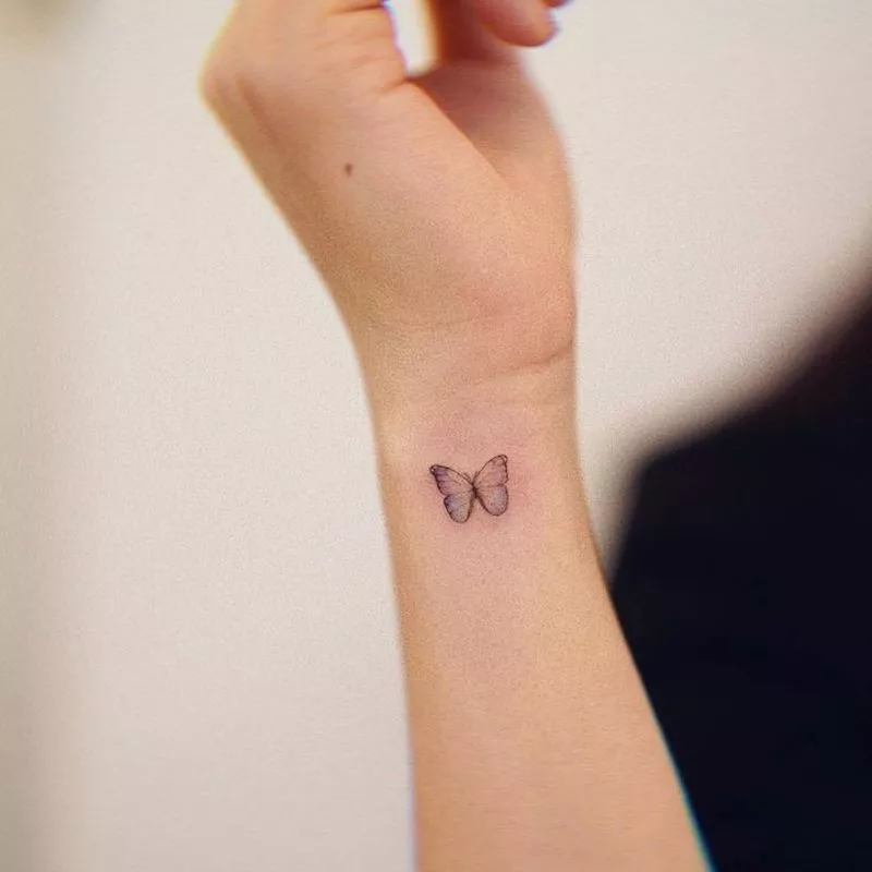 Small butterfly wrist tattoo