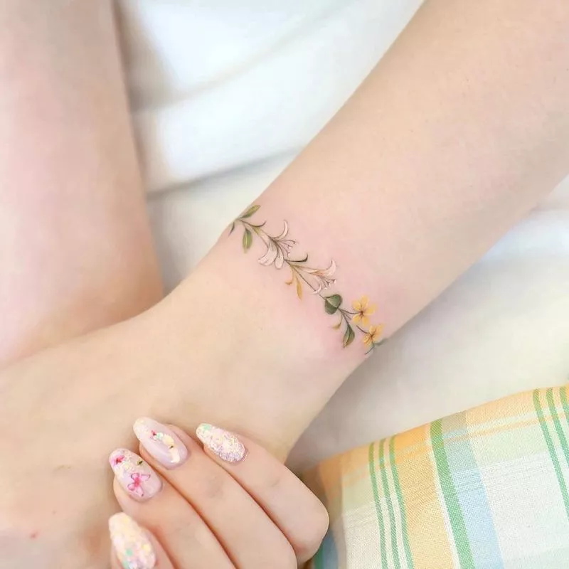 Floral chain tattoo around wrist