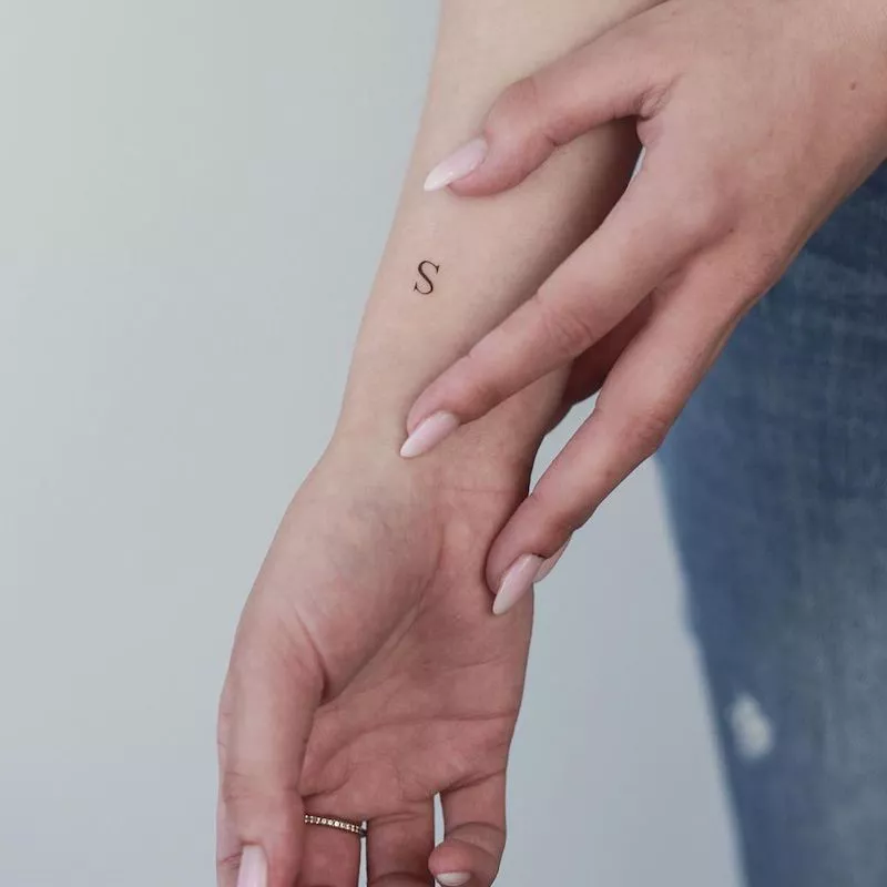Letter S tattoo on wrist
