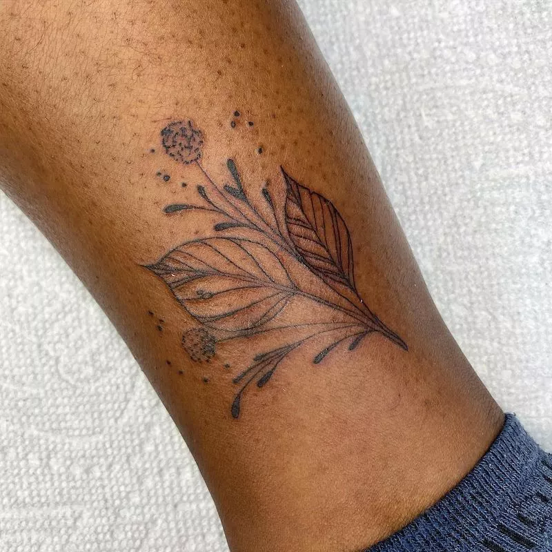 Leaf bouquet leg tattoo