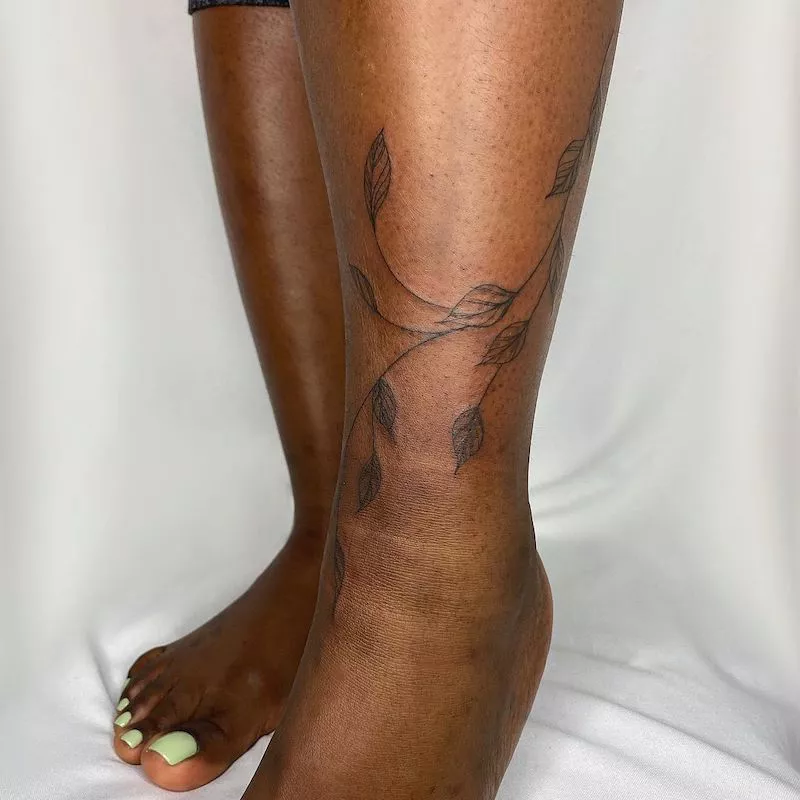 Vine tattoo wrapped around lower leg