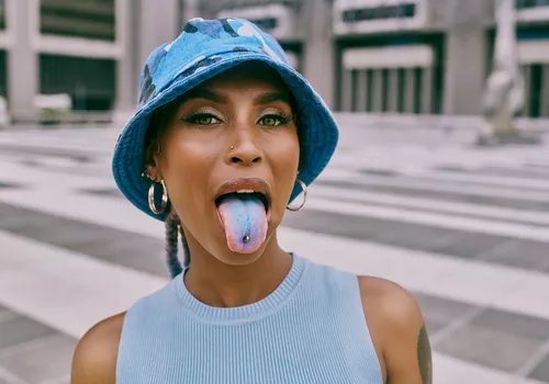 Woman with blue tongue and tongue piercing
