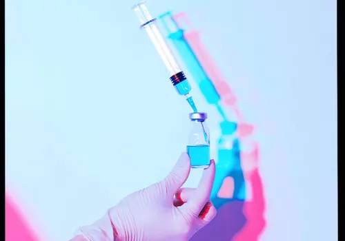syringe against blue background