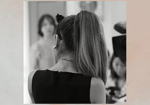 Ariana Grande from the back, neck tattoo visible