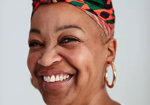 woman smiling with head wrap