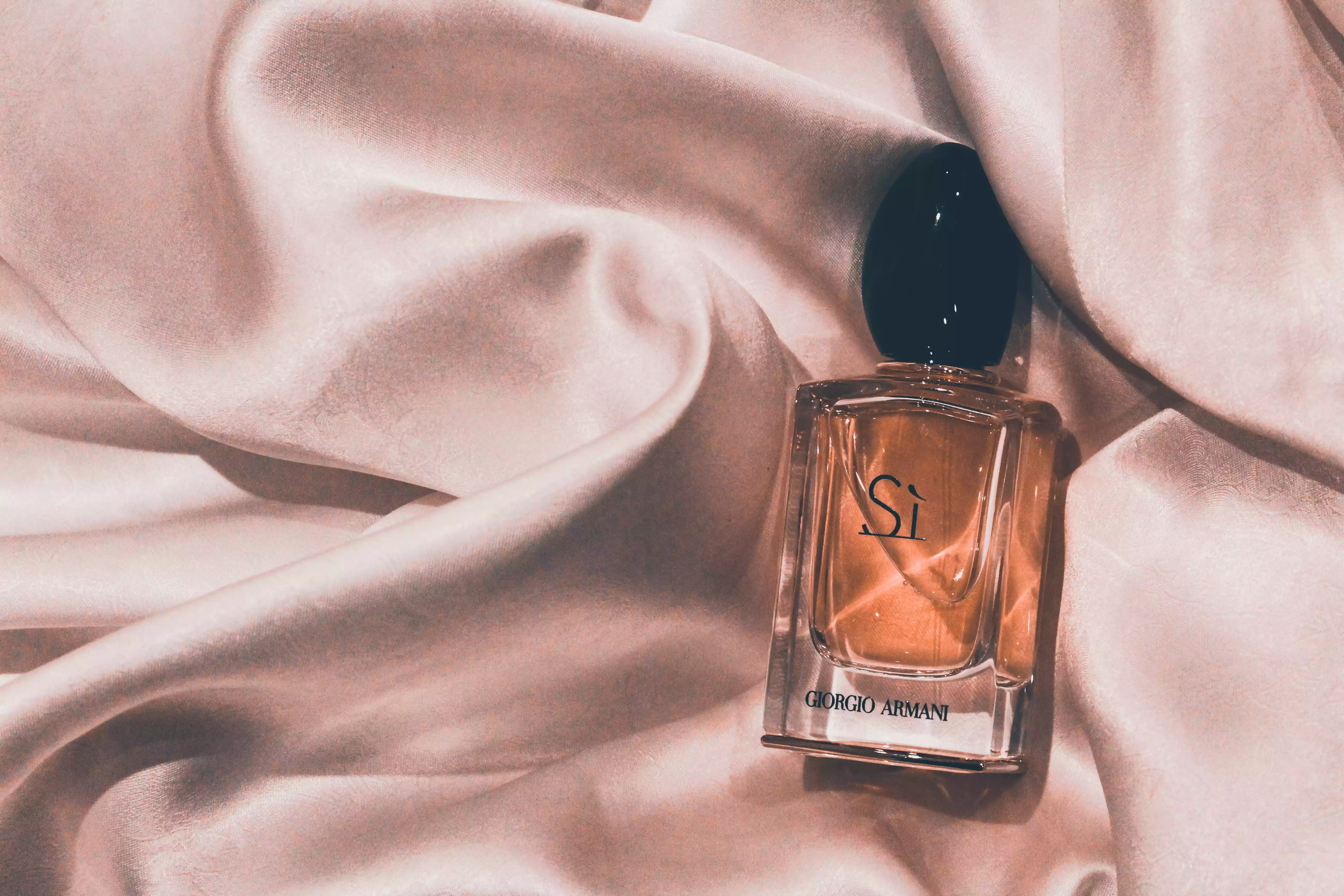 giorgio armani fragrance on bed