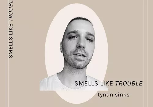 byrdie contributor tynan sinks poses for his "smells like trouble" column