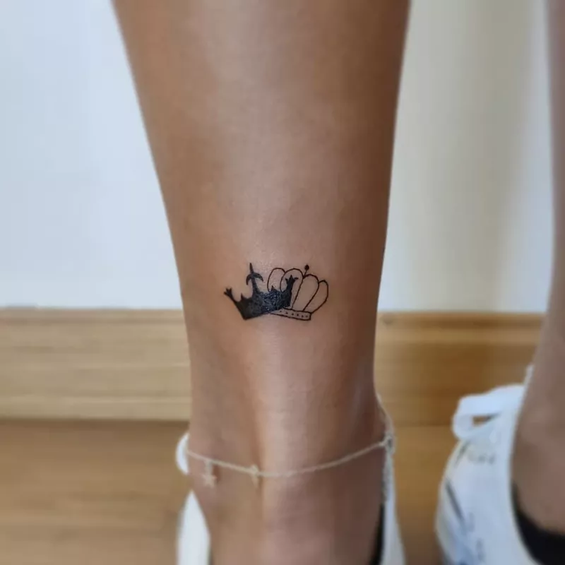 Interlocking crown tattoo on ankle