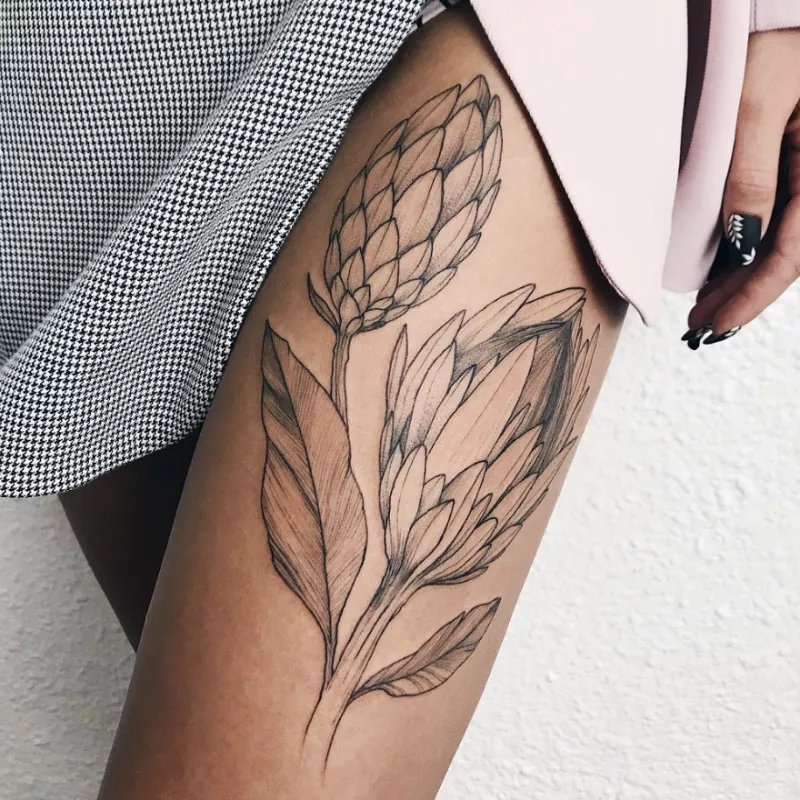 Large leaf and bud thigh tattoo