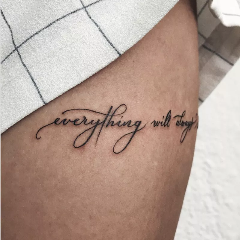 quote tattoo on side of thigh