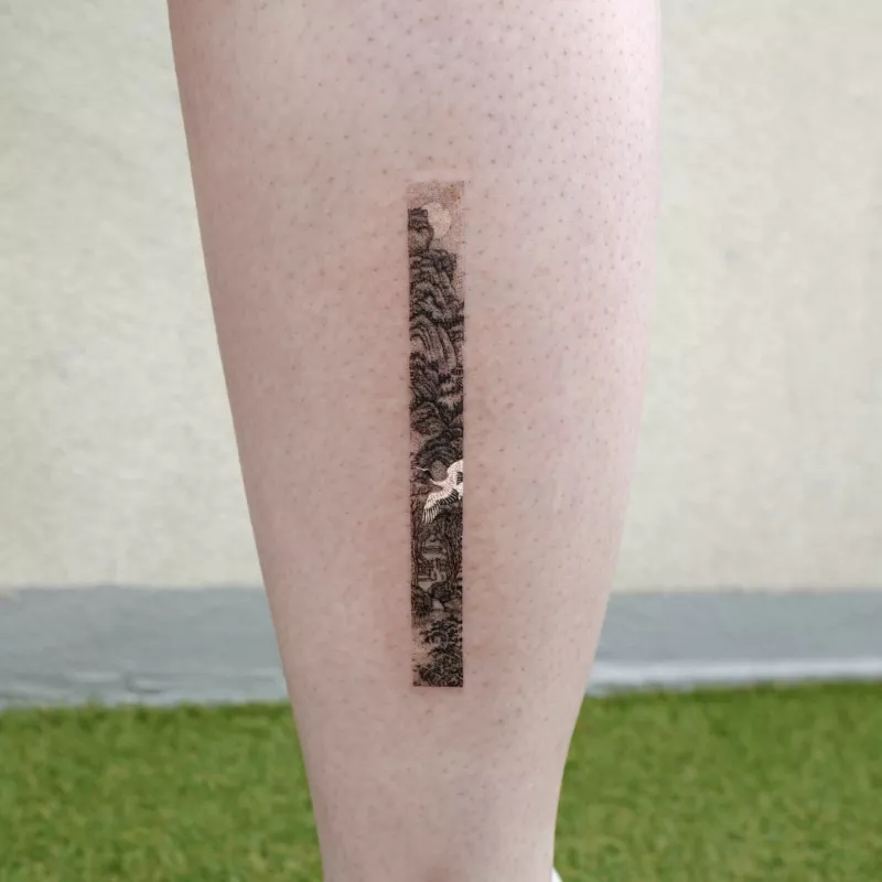 Delicate strip tattoo on back of calf