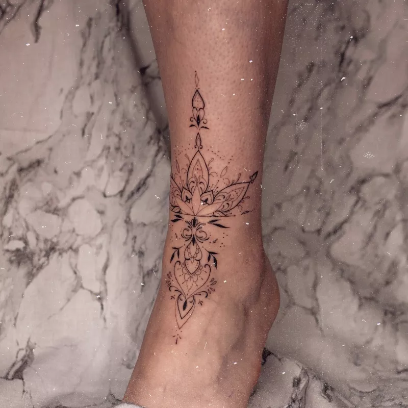 ornate pattern ankle tattoo