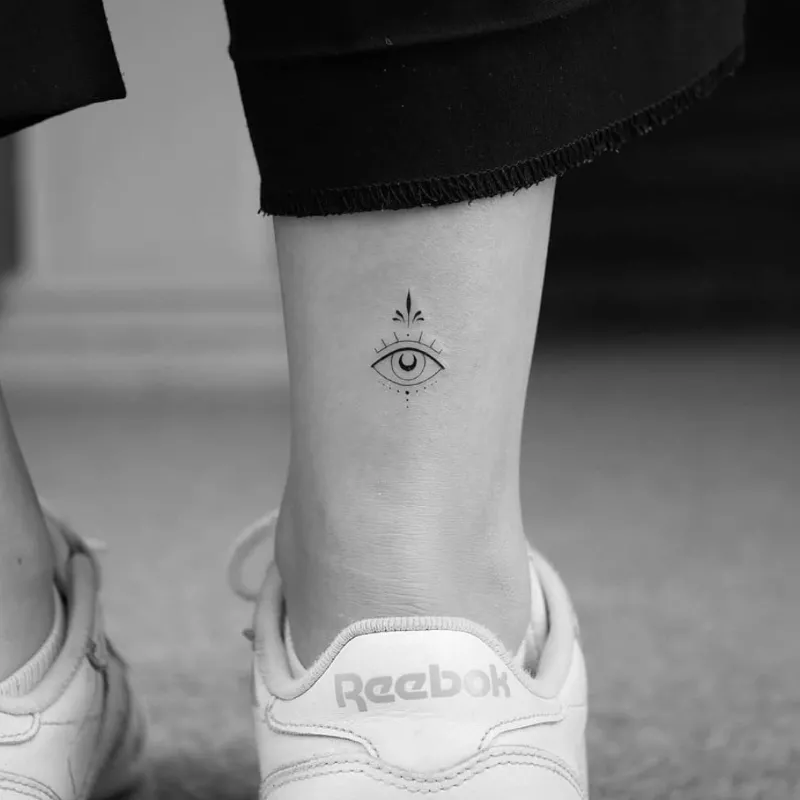 ankle tattoo of ornate eye