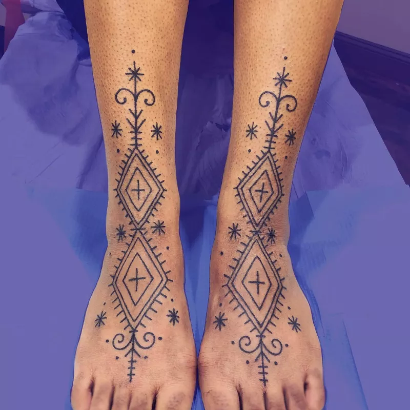 thick multi-diamond and star tattoo design on lower legs and feet