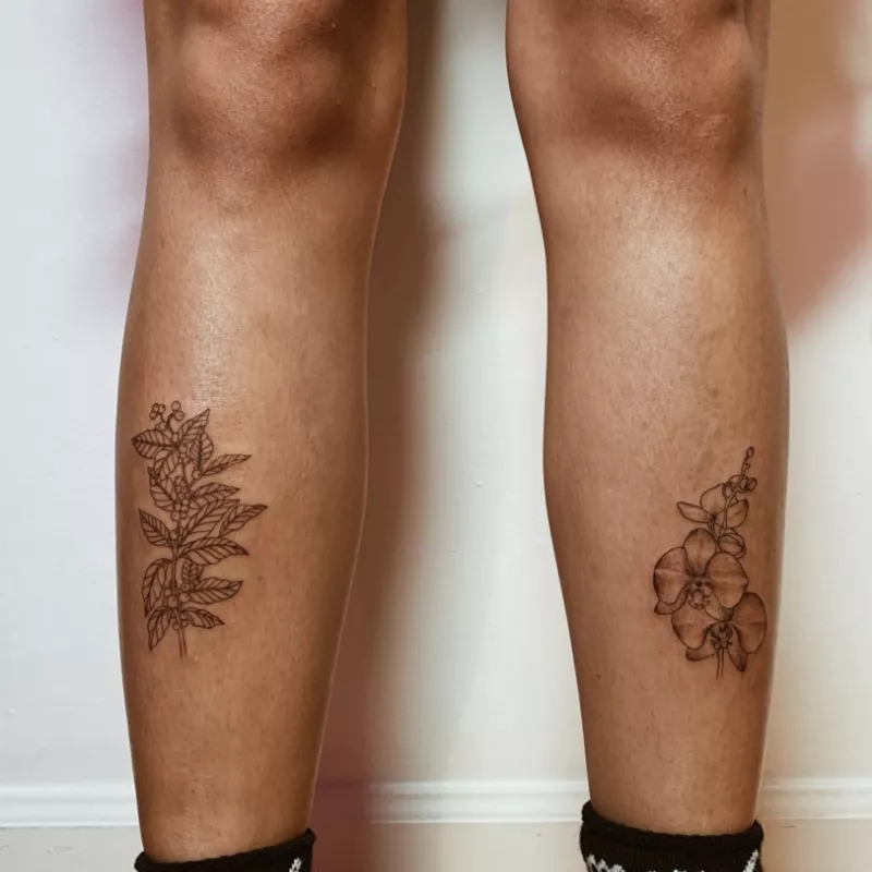 Flower and leaves lower leg tattoos