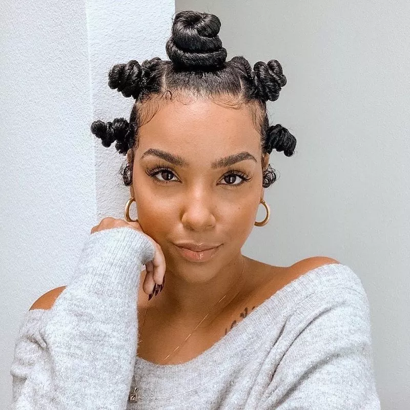 Woman with Bantu knots hairstyle with large center knot