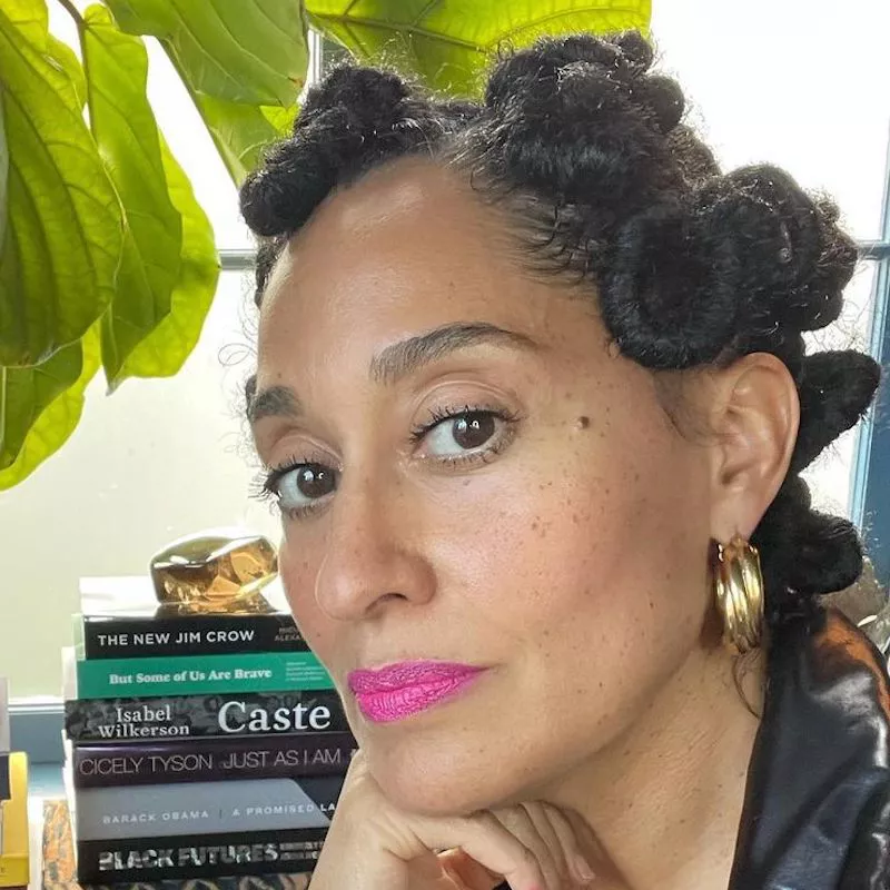 Tracee Ellis Ross wears a twisted bantu knot hairstyle and bright pink lipstick