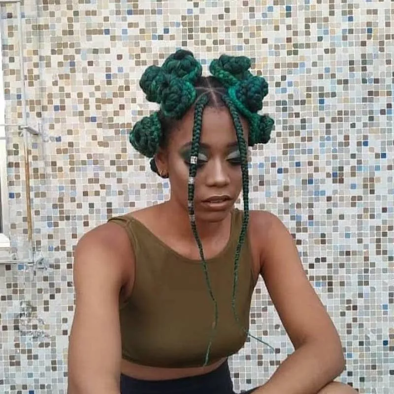 Woman with green Bantu knots and face-framing braids