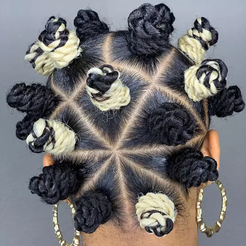 Back of braided Bantu knot hairstyle with star-shaped part and woven platinum pieces