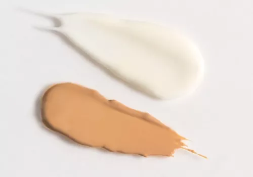 two swatches of sunscreen on white background