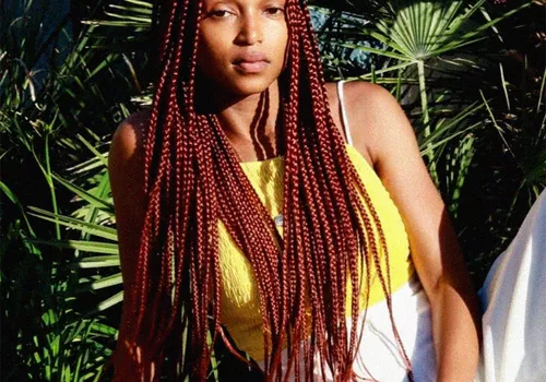 person with red box braids