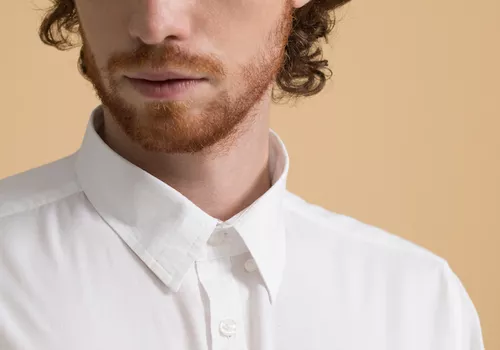 Up close of a masculine person with a red beard. 