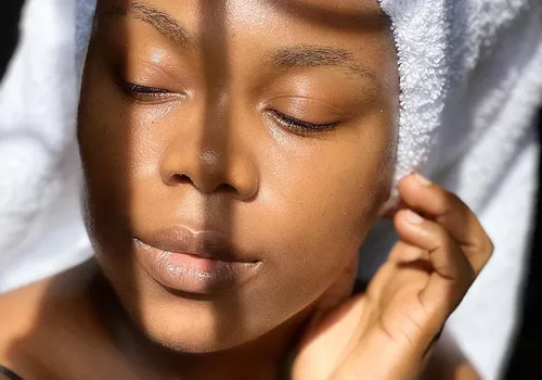 woman with glowing skin in towel