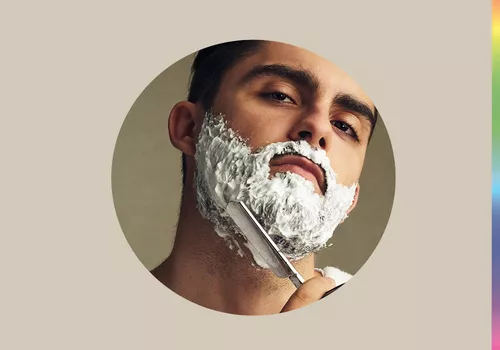 Man shaves with a straight razor