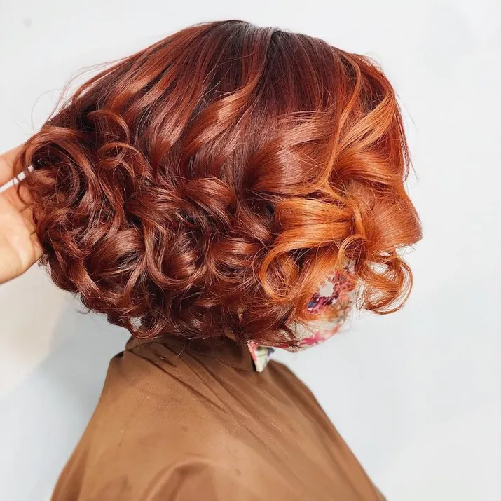 Curled red bob with orange face-framing pieces