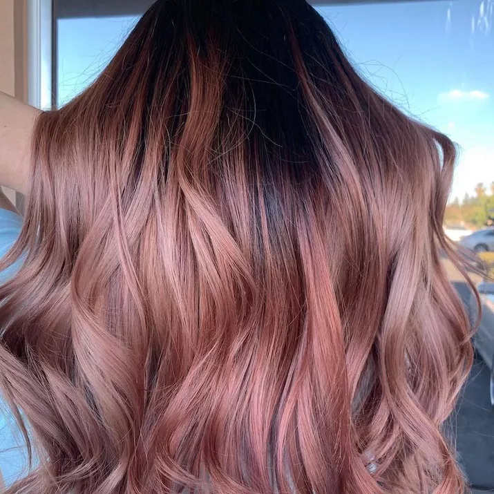 Back view of long hair with rose gold balayage