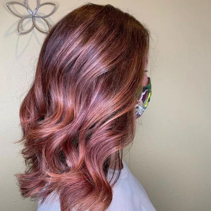 Shiny rose gold balayage hair with smooth curls
