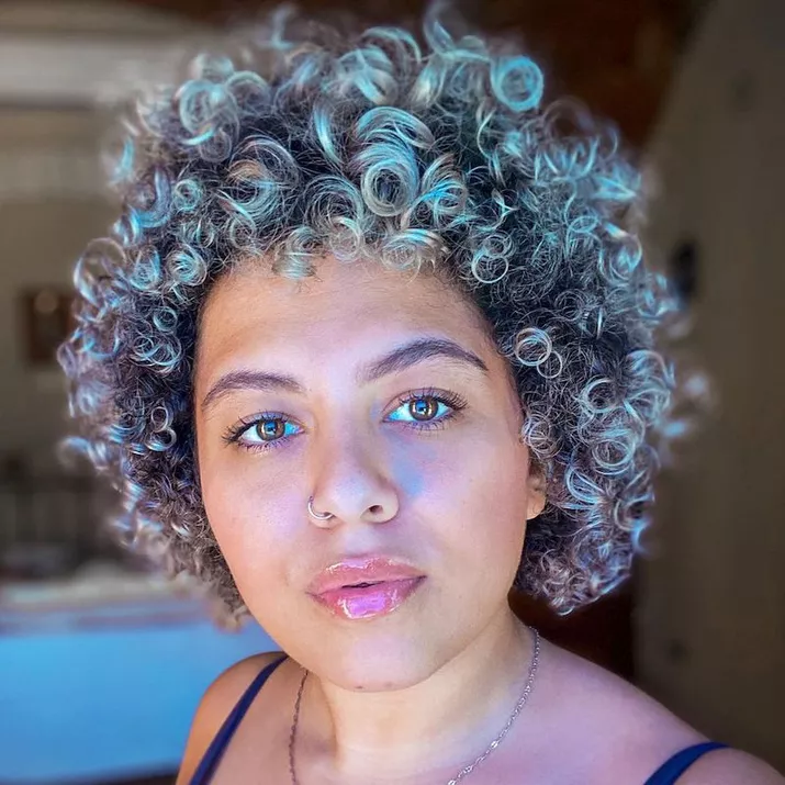 Woman with cool-toned titanium curls