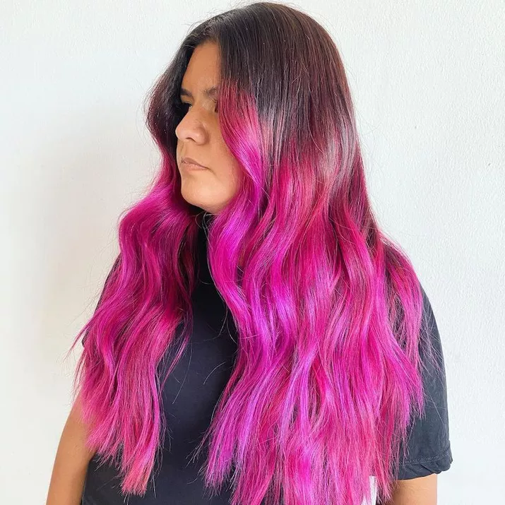 Woman with vivid fuchsia extra-long pink ombre hair