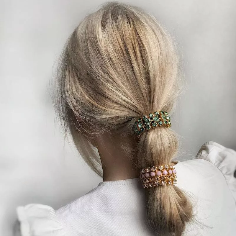 Blonde looped ponytail with colorful bedazzled hair cuffs