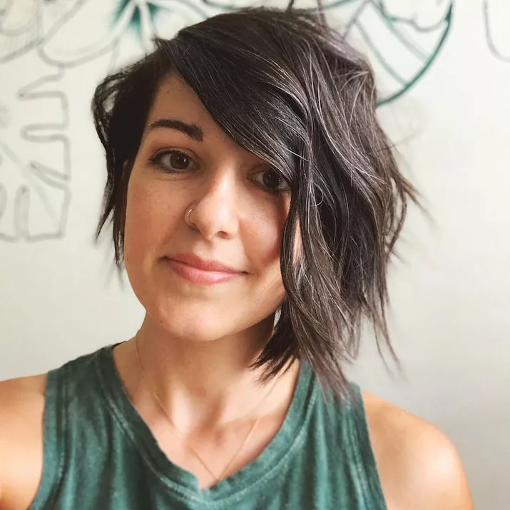 Woman wears asymmetrical bob with tousled waves