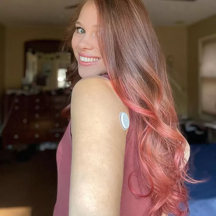 Woman with long pink ombre hair with sandy brown base
