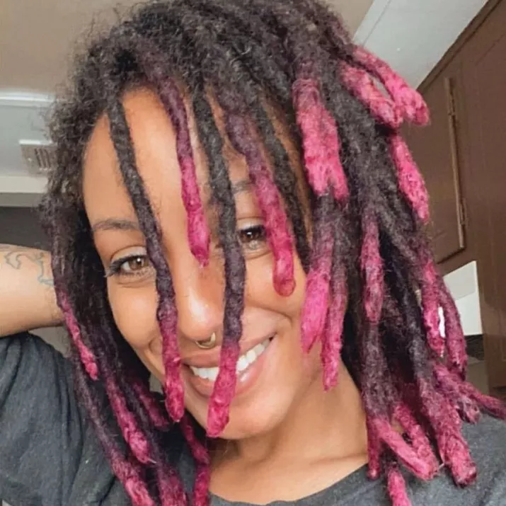 Woman with hot pink ombre dipped dreadlock hairstyle