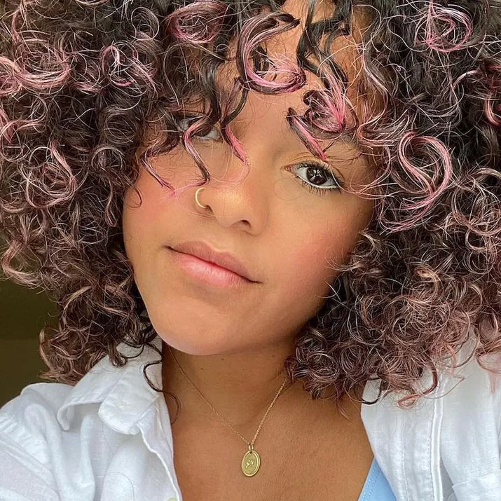 Woman with light pink ombre natural curls
