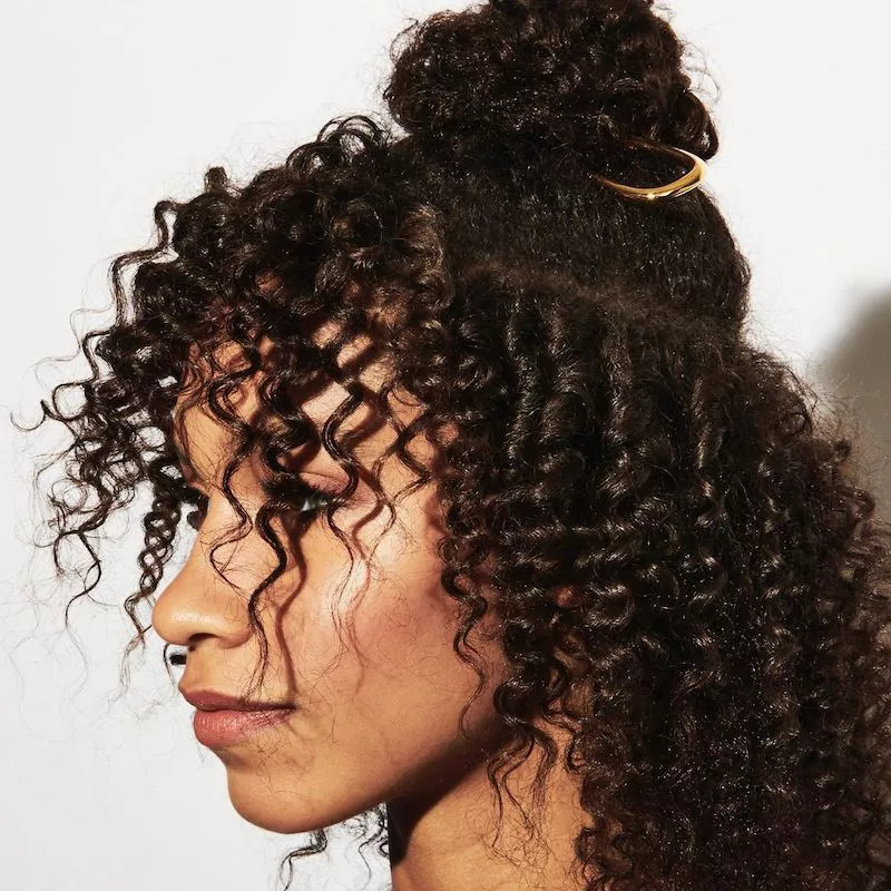 Curly half-up hairstyle with french pins