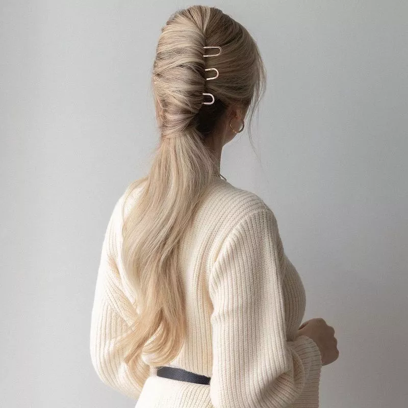 Long, blonde French pin ponytail hairstyle viewed from back