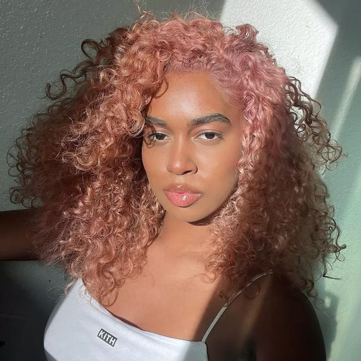 Model with pastel peach curly natural hair