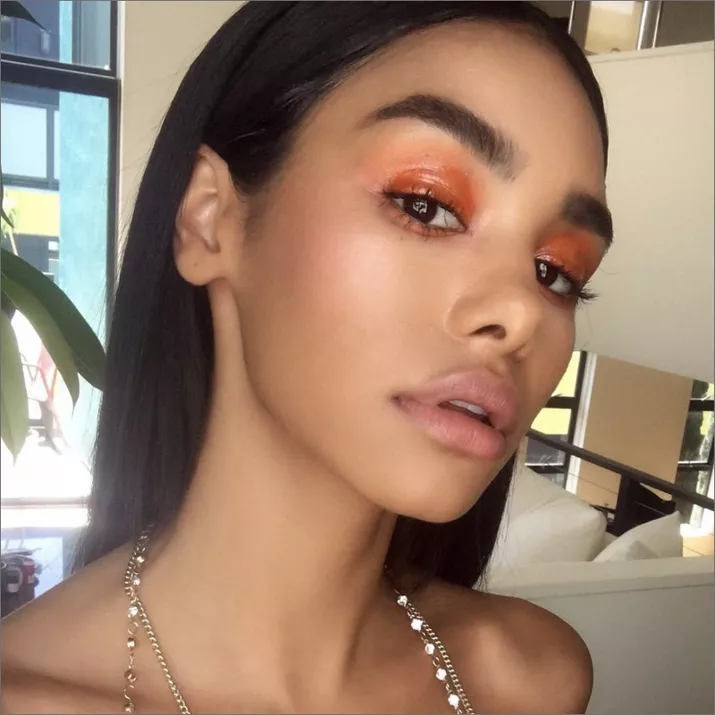 woman with orange eyeshadow and neutral makeup
